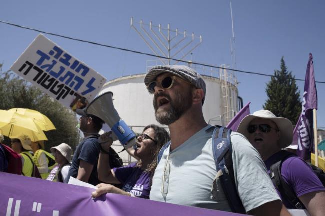 Israelis march to protest against plans by Prime Minister Benjamin Netanyahu's government to overhaul the judicial system, in the West Bank settlement of Kdumim, the home of right-wing lawmaker and Minister of Finance Bezalel Smotrich, Friday, July 28, 2023. While many lawmakers' homes have been the site of anti-overhaul protests, this was a rare protest inside an Israeli settlement. (AP Photo/Maya Alleruzzo)