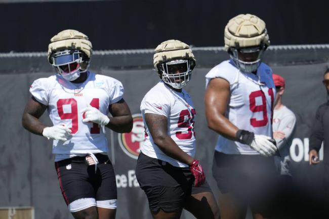 From left, the 49ers’ Clelin Ferrell, Javon Hargrave and Arik Armstead take part in drills during training camp Wednesday in Santa Clara. (Jeff Chiu / ASSOCIATED PRESS)