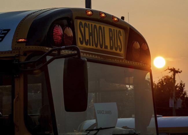 Sunrise on the first day of school at the Jefferson County Public Schools Detrick Bus Compound at 3686 Parthenia Ave., Wednesday, Aug. 9, 2023, in Louisville, Ky. Kentucky's largest school system cancelled the second and third day of classes after a disastrous overhaul of the transportation system that left some children on buses until just before 10 p.m. on opening day. (Jeff Faughender/Courier Journal via AP)