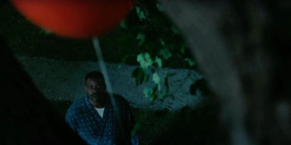 A guy looking up at Pennywise's red ballon in the IT prequel show Welcome to Derry 