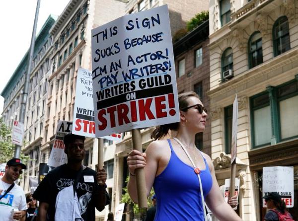 Members of the Writers Guild of America and the Screen Actors Guild walk a picket line outside of Warner Bros. in New York on July 13, 2023. Actors were poised to go on strike July 13, joining writers in the first industry-wide shutdown in 63 years after last-ditch talks failed, with nearly all film and television production likely to grind to a halt. SAG-AFTRA, which represents 160,000 performers including A-list stars, said negotiations late July 12 had ended without a deal.