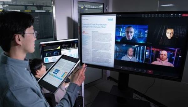 This photo provided by SK Telecom Co. on Feb. 1, 2024, shows its employees talking with officials from U.S. chipmaker Intel on latency reducing technology for the sixth generation network. (PHOTO NOT FOR SALE) (Yonhap) 