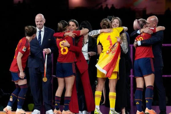 FILE - President of Spain's soccer federation, Luis Rubiales, right, hugs Spain's Aitana Bo<em></em>nmati on the podium following Spain's win in the final of Women's World Cup soccer against England at Stadium Australia in Sydney, Australia, Sunday, Aug. 20, 2023. At left is Spain's Princess Infanta Sofia. (AP Photo/Alessandra Tarantino, File)